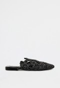 Zueco plano de mujer de rafia trenzada negra con diseño artesanal y estilo veraniego minimalista VAS 100251428